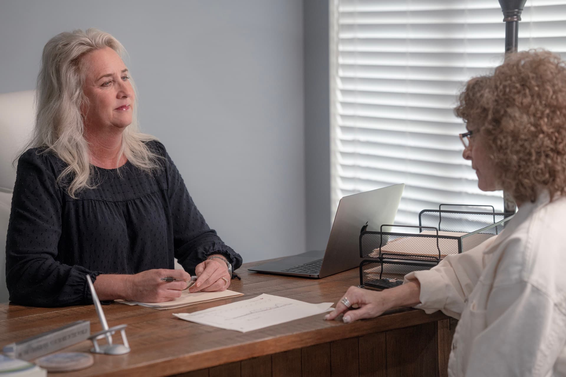 Teresa Mealy, APRN, FNP reviewing a testosterone and metabolic lab panel with a female patient