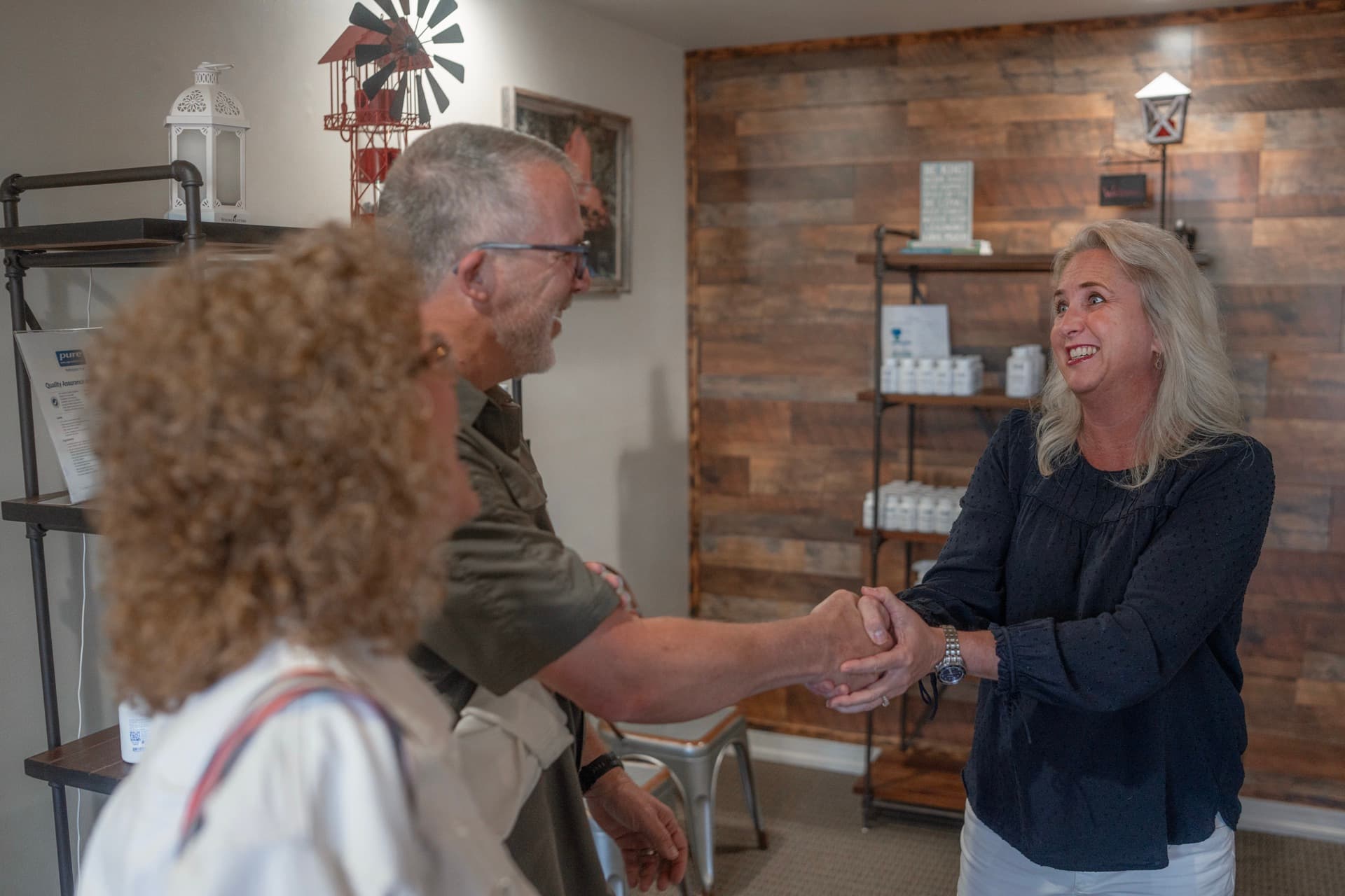 Teresa shaking hands with a patient on her way out of the clinic