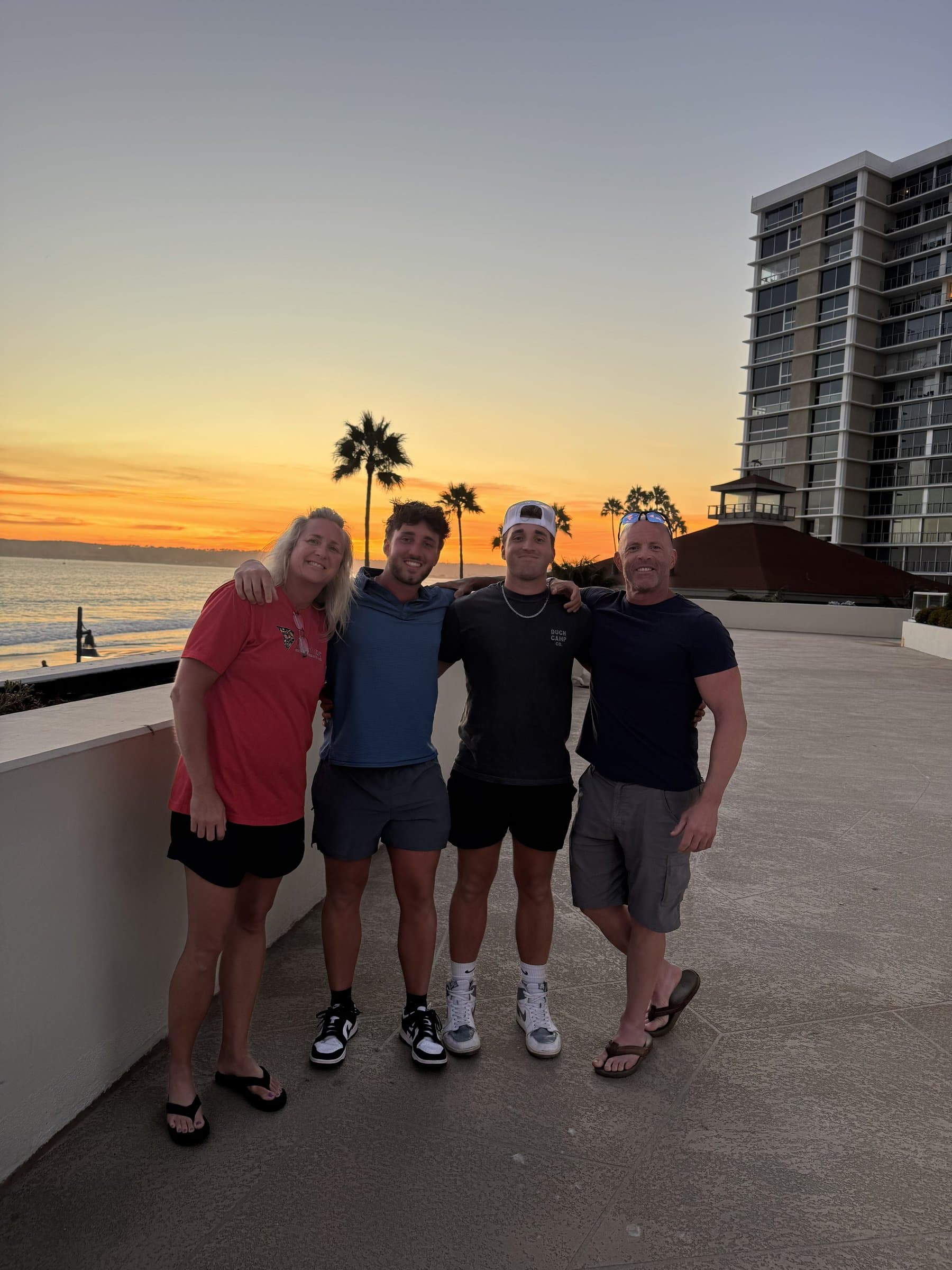 Teresa and Mark Mealy with their sons Nate and Blake at sunset on the beach